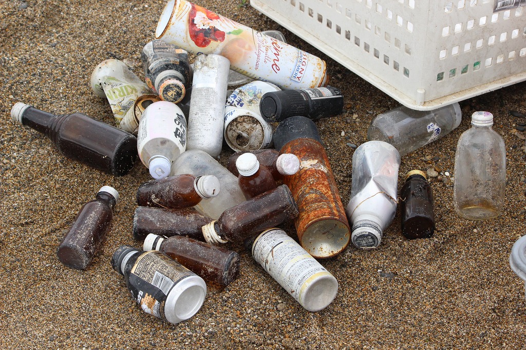 海から打ち上げられた様々なゴミを分別しながら回収する参加者